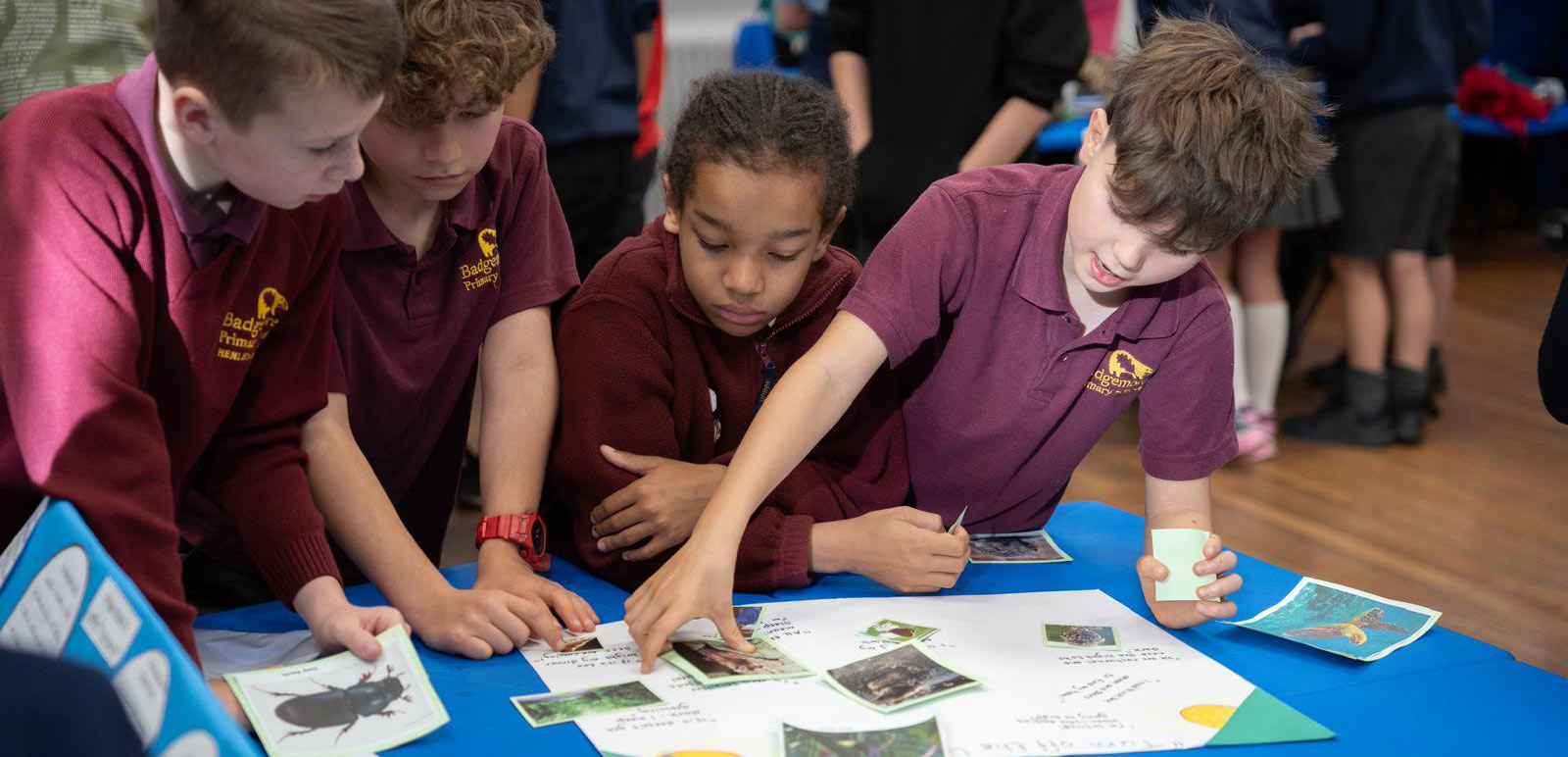 A group of school children come together doing an exercise at the science fair